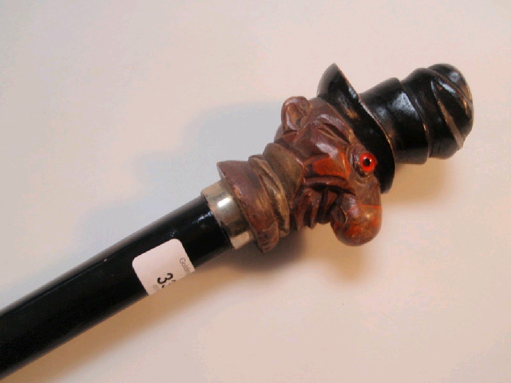 Appraisal: An ebonised walking cane the head carved as Ally Sloper