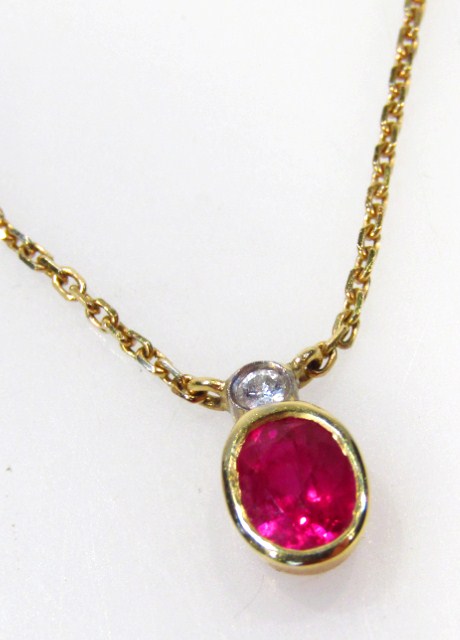 Appraisal: A slender pendant of oval outline set with ruby surmounted