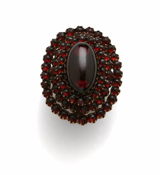 Appraisal: A garnet and k gold large ring centering an oval