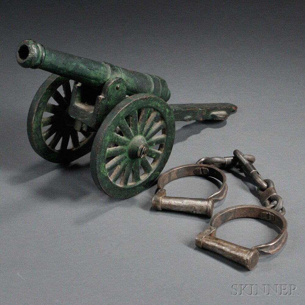 Appraisal: Cannon and Handcuffs c th century iron cannon with green