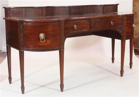 Appraisal: An Empire style mahogany serpentine sideboard with tambour gallery over