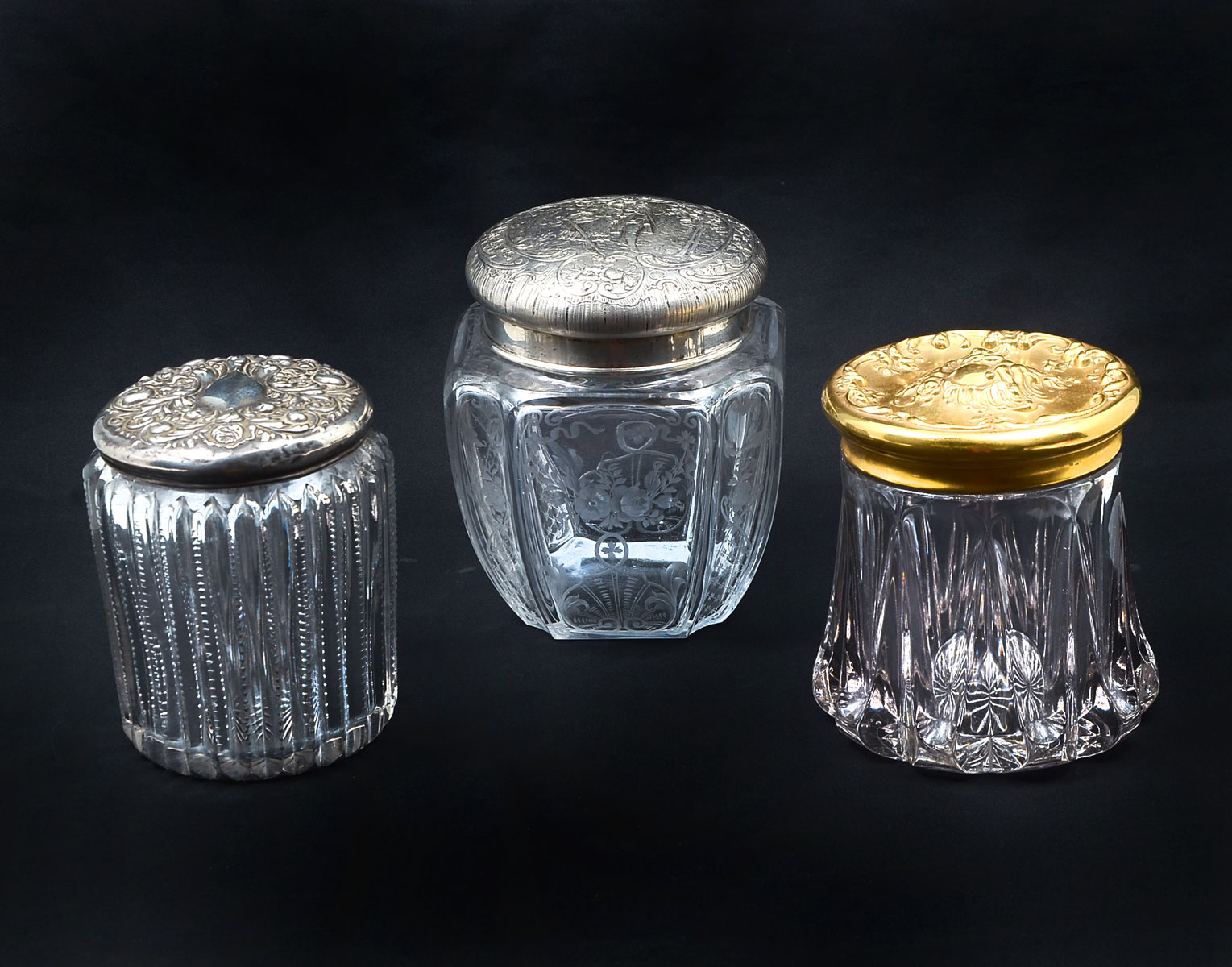 Appraisal: STERLING CRYSTAL HUMIDORS Comprising - Gold toned scrolling foliate lidded