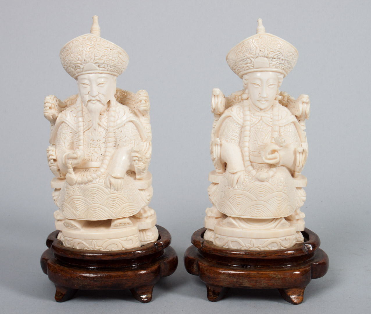 Appraisal: Chinese carved ivory emperor and empress each modeled as seated