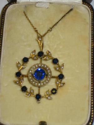 Appraisal: A SAPPHIRE AND SEED PEARL BROOCH PENDANT of circular form