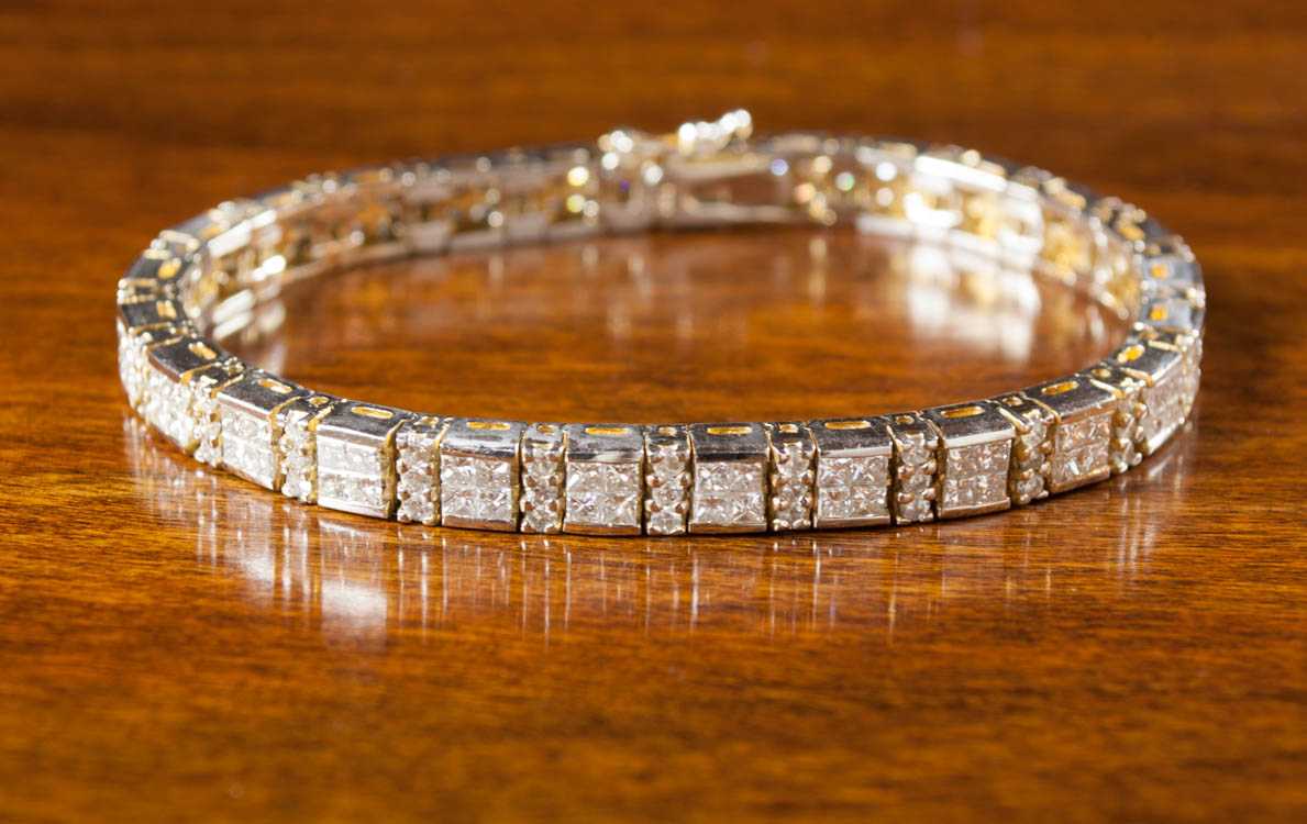 Appraisal: DIAMOND AND FOURTEEN KARAT GOLD TENNIS BRACELET white and yellow