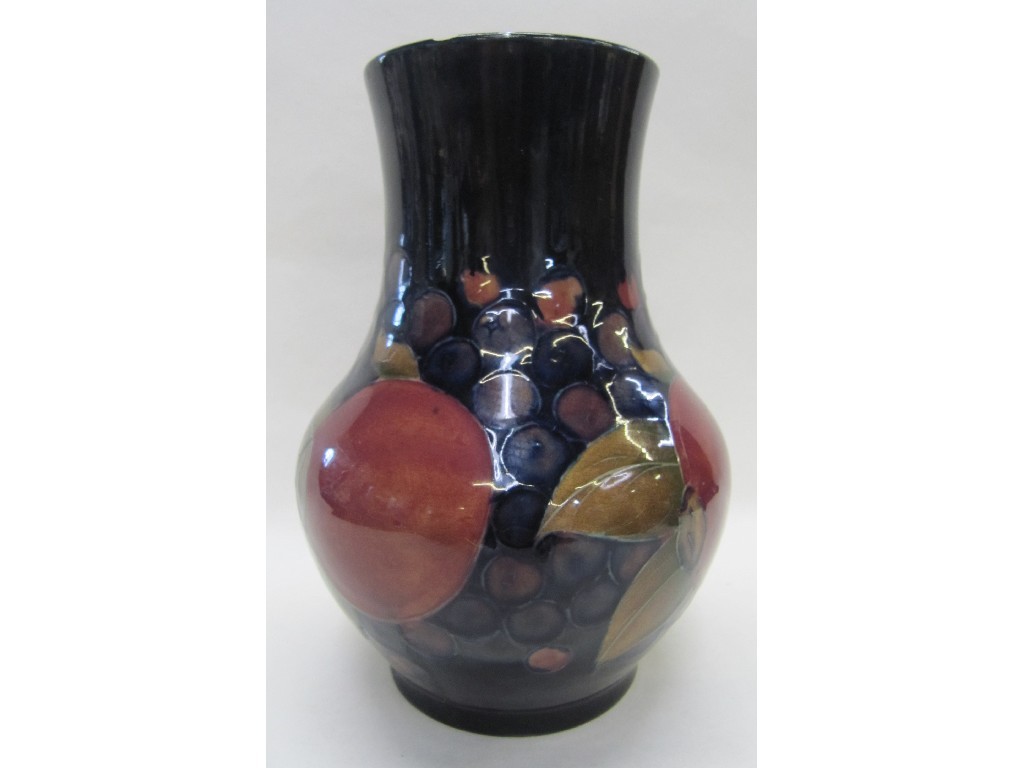 Appraisal: Moorcroft 'Pomegranate' pattern vase on dark blue ground chip to