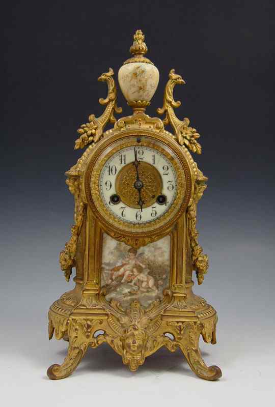 Appraisal: WATERBURY GILT METAL SHELF CLOCK Cast metal cast featuring cherub