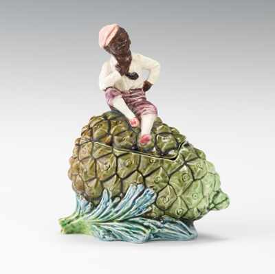 Appraisal: A Black Figural Majolica Artichoke Humidor Seated black boy with