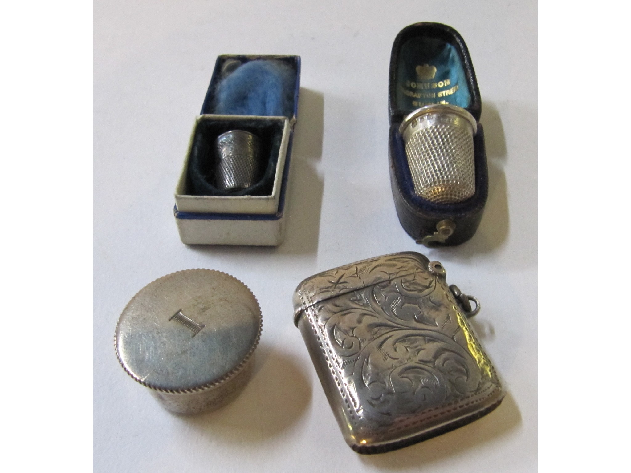 Appraisal: A lot comprising a silver vesta two thimbles and a