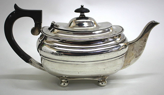 Appraisal: A SILVER TEAPOT with gadrooned border ebonised handle and knop