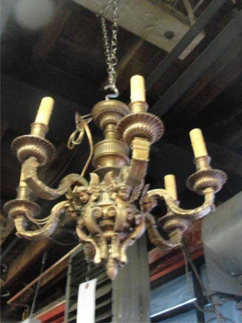 Appraisal: Arm Bronze Chandelier with Winged Putti Details From a Manhattan