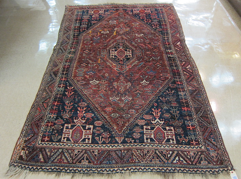 Appraisal: PERSIAN TRIBAL AREA RUG central geometric medallion and stylized flower