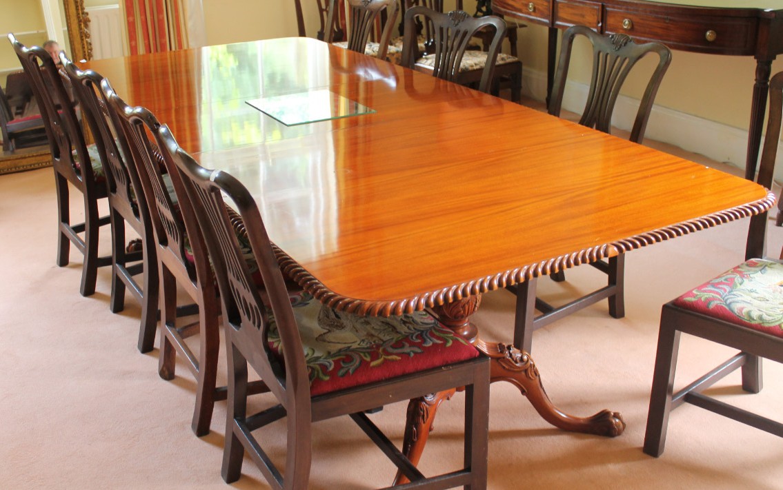 Appraisal: A reproduction Georgian mahogany twin pillar dining table with gadrooned