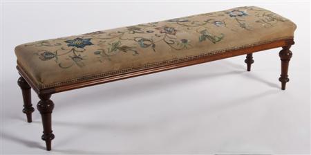 Appraisal: A Victorian mahogany long stool the floral needlepoint cushioned seat