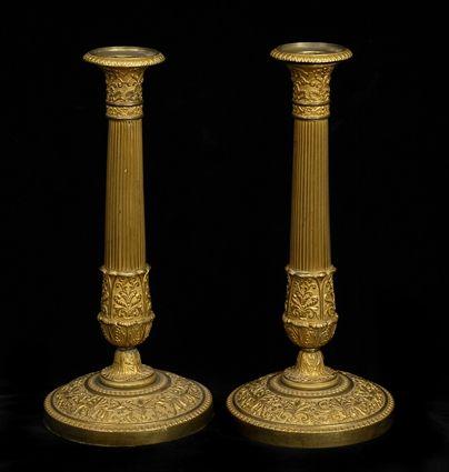 Appraisal: PAIR OF EMPIRE GILT-BRONZE TABLE CANDLESTICKS Each reeded stem with