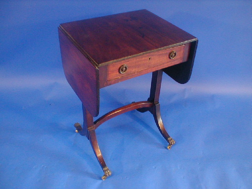 Appraisal: A small antique mahogany sofa table in the Regency manner