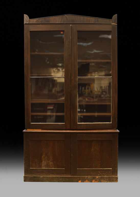 Appraisal: American Classical carved mahogany glass panel bookcase circa pedimented cornice