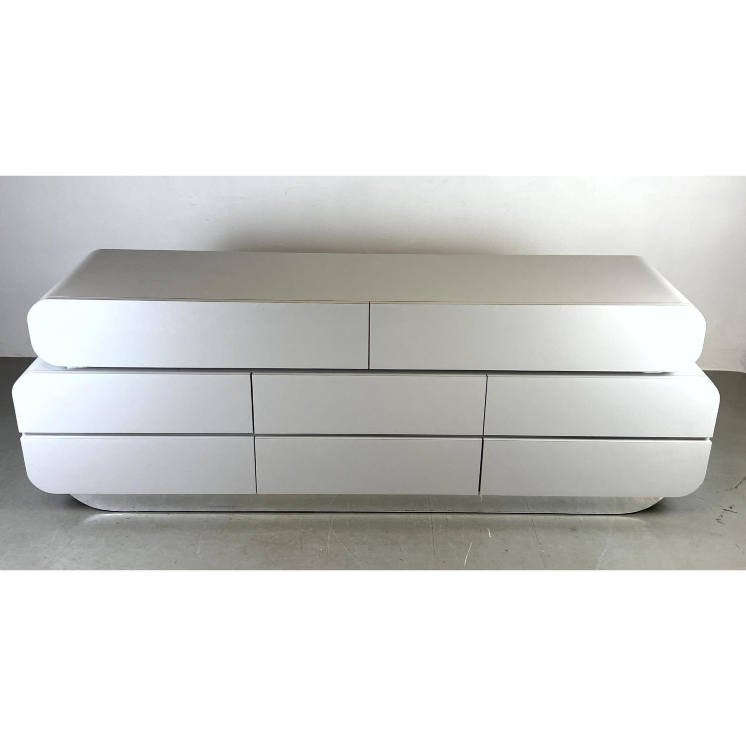 Appraisal: White Laminate Modernist Credenza Dresser Levels of drawers above silver