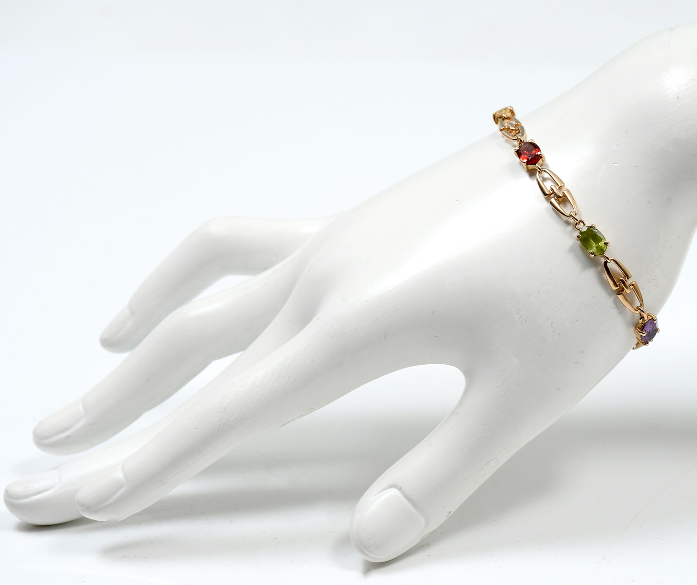 Appraisal: K GEMSTONE BRACELET K yellow gold bracelet contains faceted gemstones