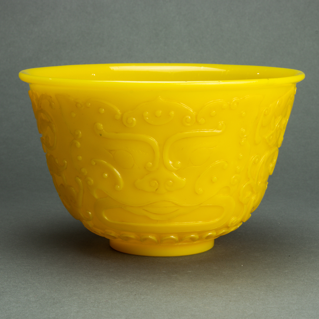 Appraisal: PEKING YELLOW GLASS BOWL Peking yellow glass bowl carved in