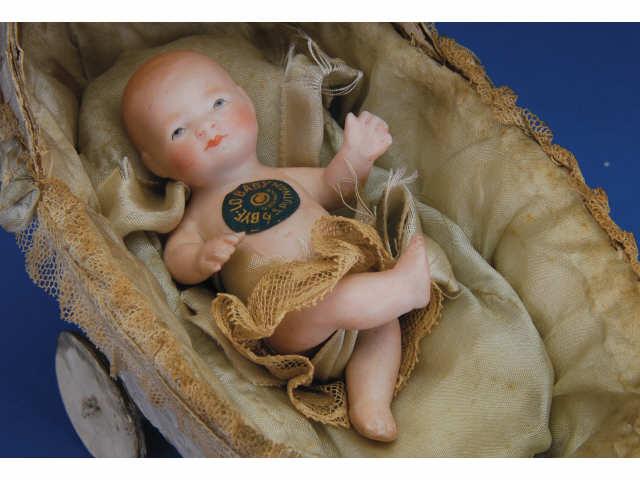 Appraisal: Action Bye-Lo Baby in Original Carriage Germany ca one-piece all