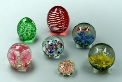 Appraisal: Seven assorted paperweights one with three pink flowers in one