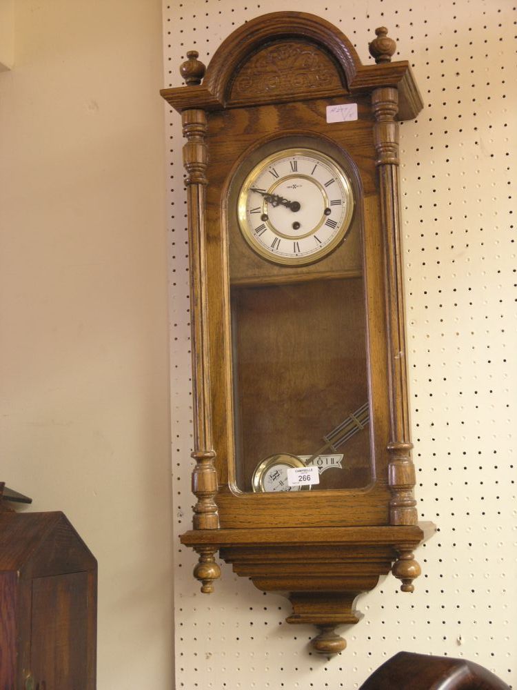 Appraisal: A medium oak wall clock traditional case with finials three