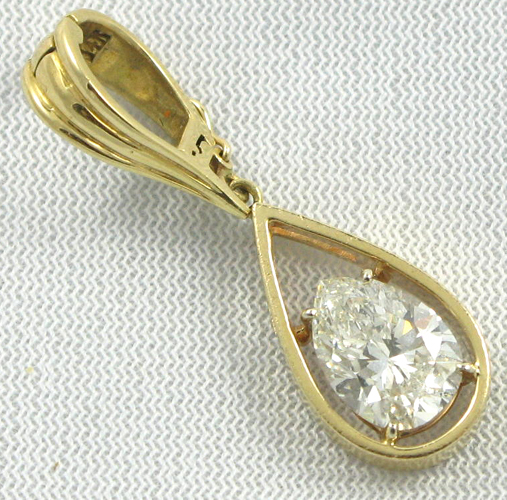 Appraisal: DIAMOND AND EIGHTEEN KARAT GOLD PENDANT set with a pear-cut