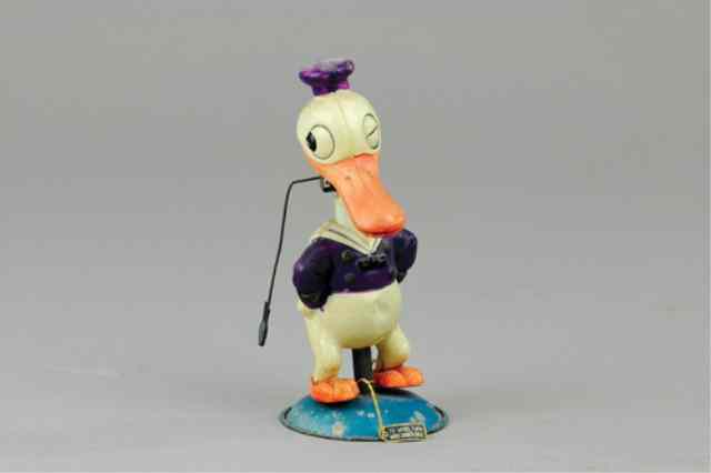 Appraisal: DONALD DUCK CELLULOID NODDER Japan full figure stands on metal