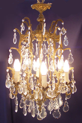 Appraisal: EARLIER TH C CRYSTAL AND BRONZED CHANDELIER lights amongst tiers