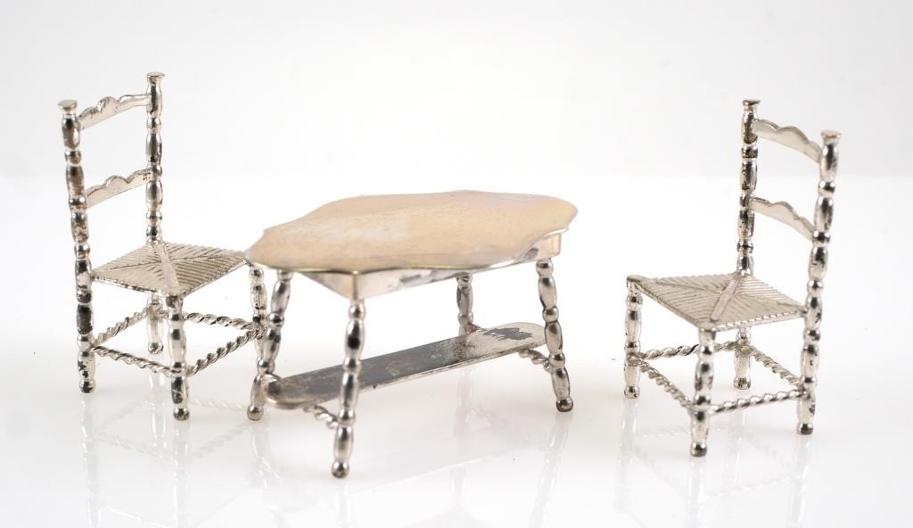 Appraisal: Dutch silver miniature table and chairs Netherlands Dutch hallmark in