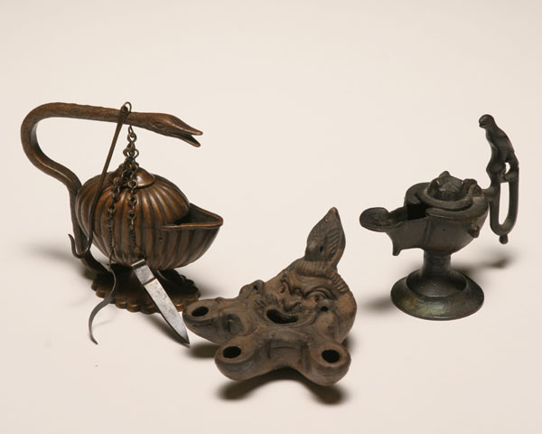 Appraisal: Three archaic style oil lamps the clay lamp in the