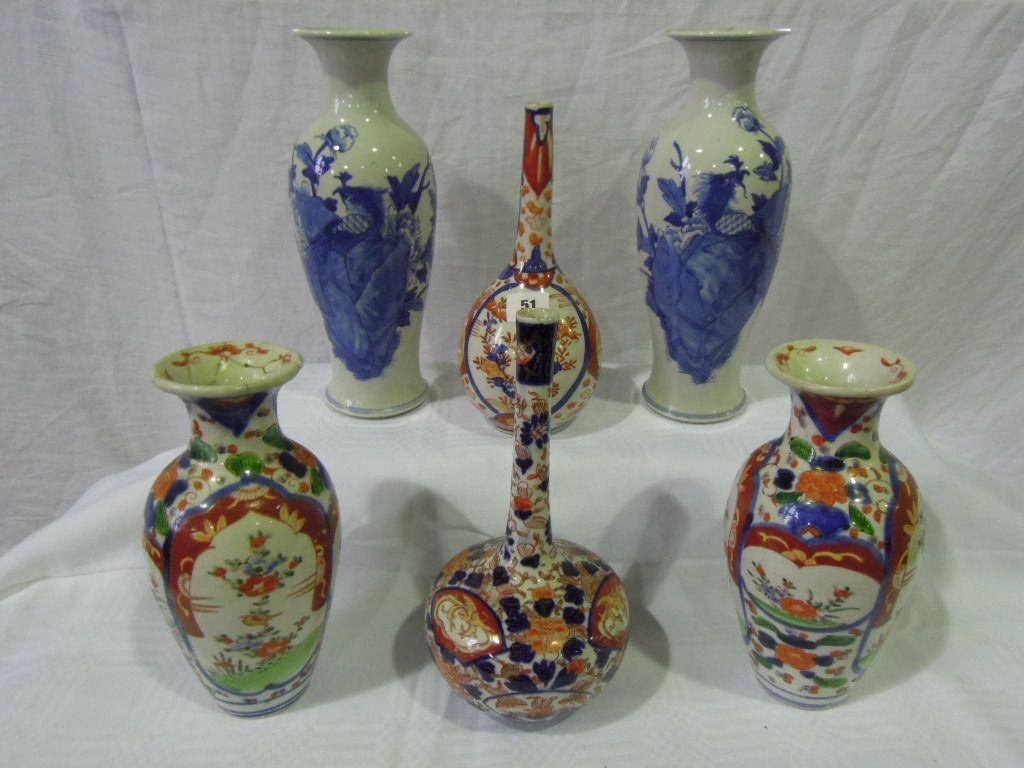 Appraisal: A pair of oriental style blue and white vases decorated