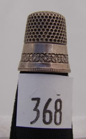 Appraisal: KMD Sterling thimble with floral design on band