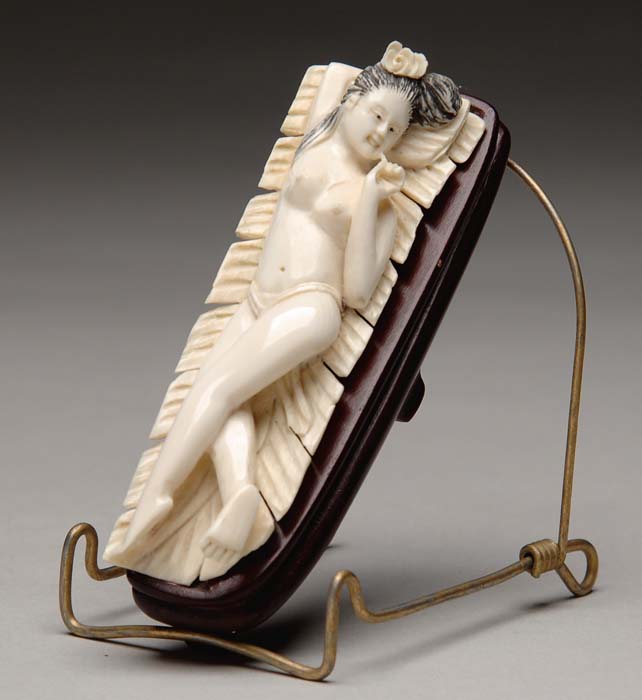 Appraisal: CARVED IVORY DOCTOR S LADY Reclining nude woman resting on