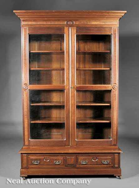 Appraisal: An American Renaissance Carved Walnut Bookcase c flared cornice paneled