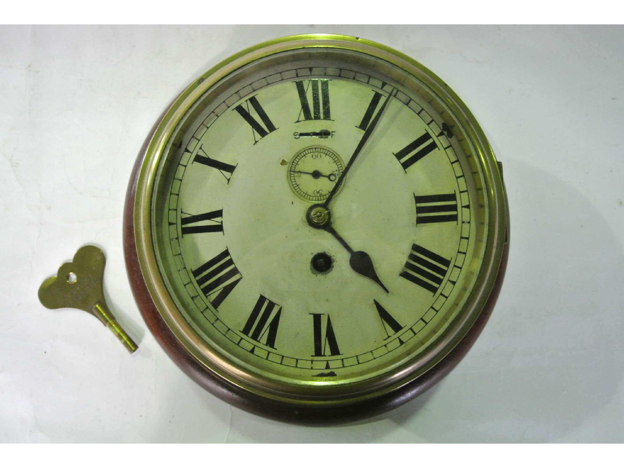 Appraisal: A bulkhead or marine clock the brass case work enclosing