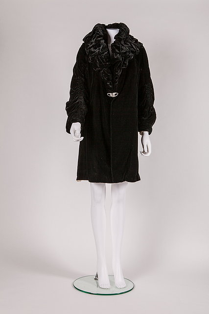 Appraisal: A s black velvet evening coat with large ruffle detailing