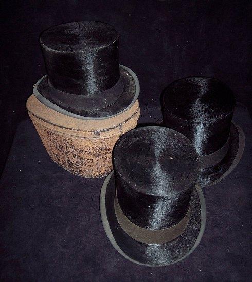 Appraisal: Three black silk top hats and a tin hat box