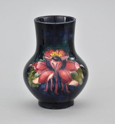 Appraisal: A Moorcroft Vase Polychrome glazed with a dark blue background