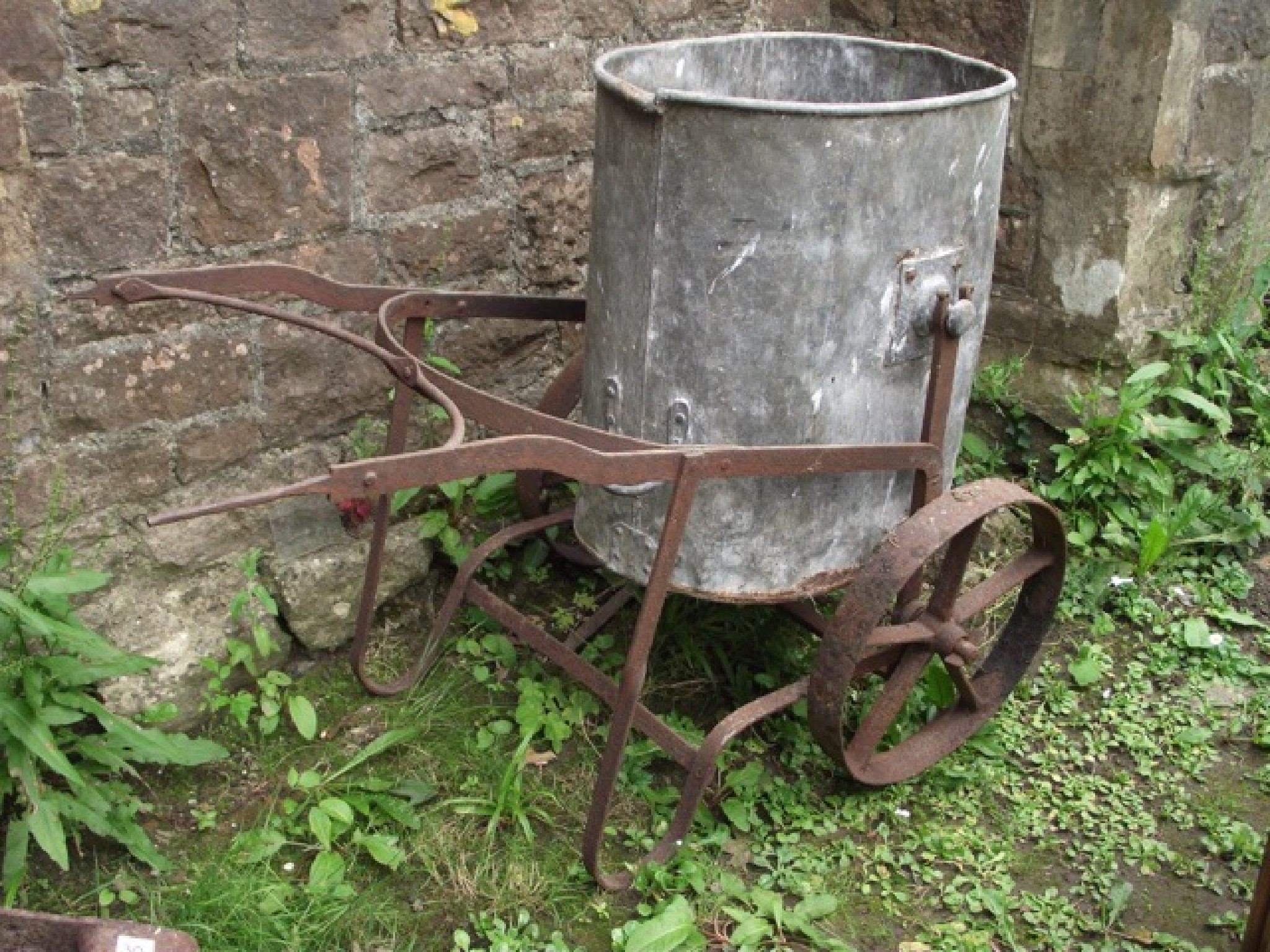 Appraisal: A vintage garden water barrow the ironwork frame with spoke