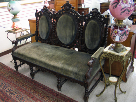 Appraisal: CARVED AND UPHOLSTERED OAK TRIPLE CHAIR-BACK SETTEE Baroque Revival style