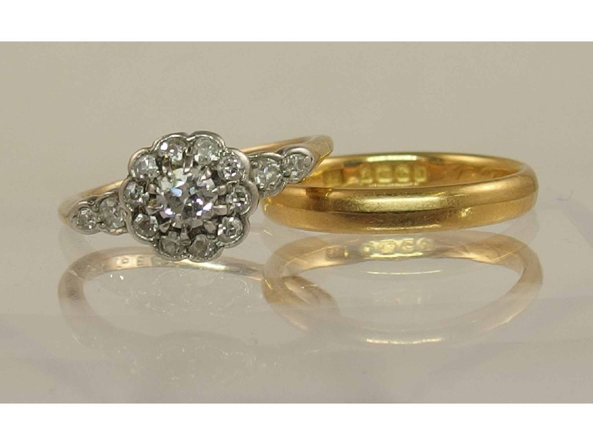 Appraisal: An ct wedding band and a diamond flower ring