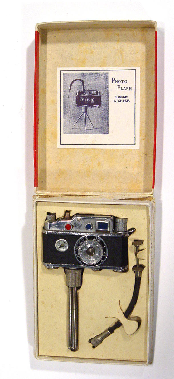 Appraisal: Boxed Japanese photo flash table lighter inset with a compass