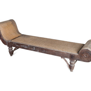 Appraisal: An Indonesian Carved Teak Chaise Longue TH CENTURY Height x