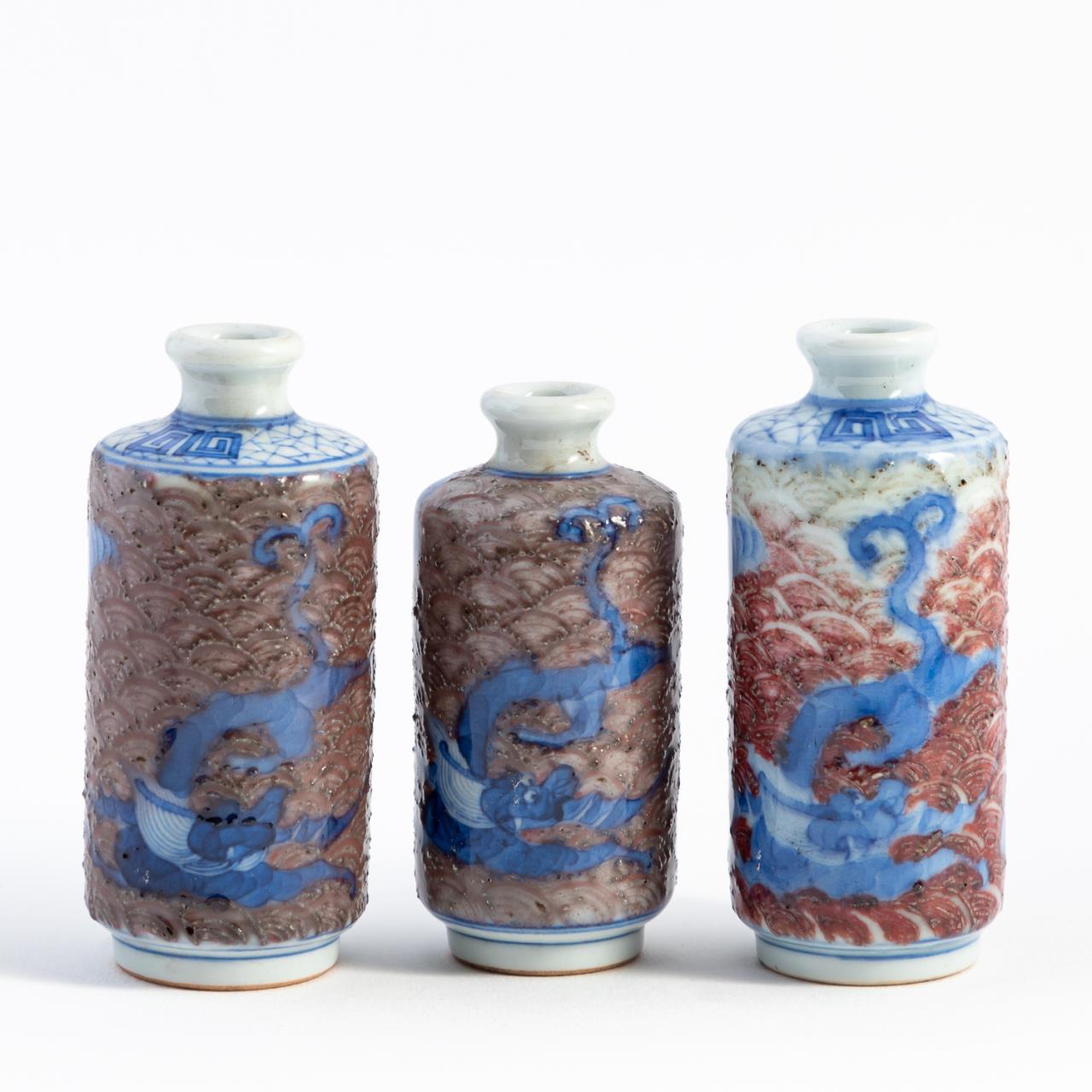 Appraisal: CHINESE BLUE WHITE IRON RED SNUFF BOTTLES Three Chinese blue