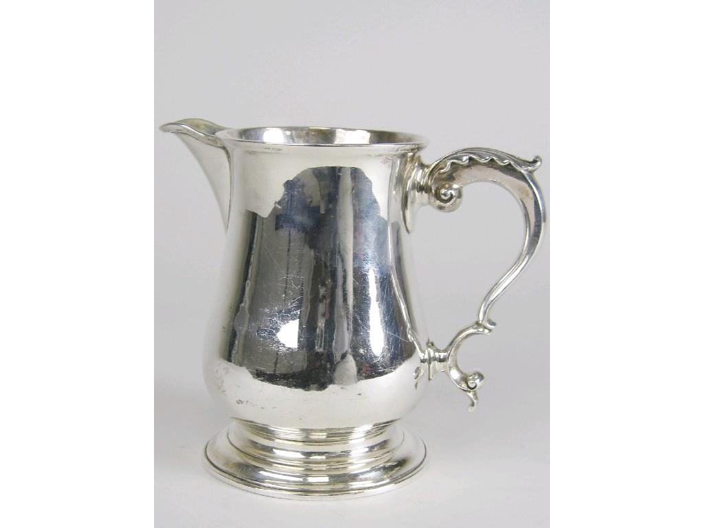 Appraisal: A George III baluster Jug with leafage scroll handle engraved