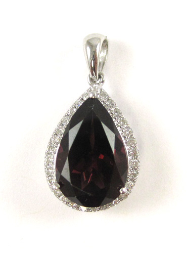 Appraisal: GARNET AND FOURTEEN KARAT WHITE GOLD PENDANT with round-cut diamonds