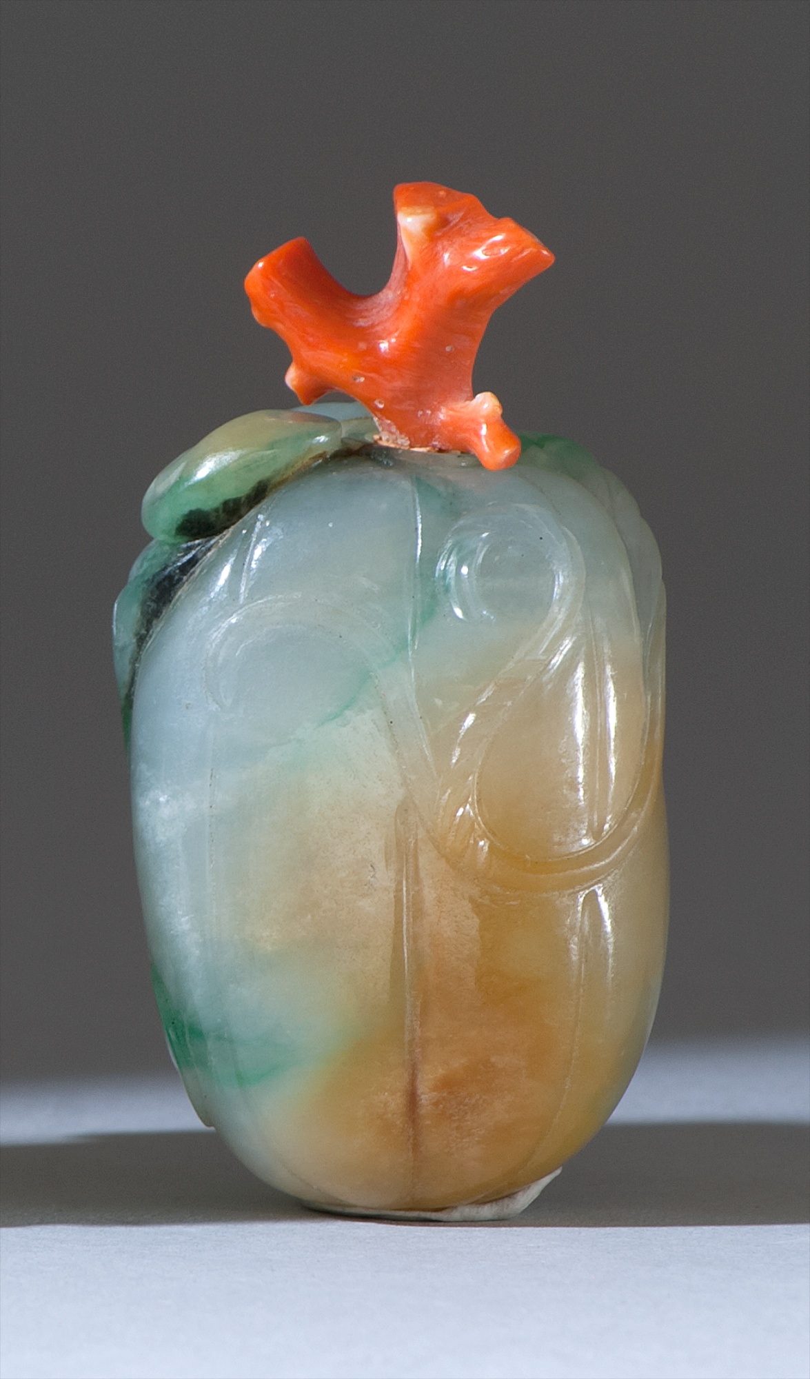 Appraisal: GREEN WHITE AND RUSSET JADE SNUFF BOTTLE th CenturyIn the