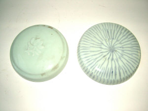 Appraisal: Two Chinese covers for jars in pale green glazes one